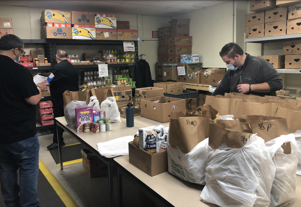 Volunteers getting together packages for clients at The Community Food Cupboard of Rochester | Photo Credit: Meribeth Weed
